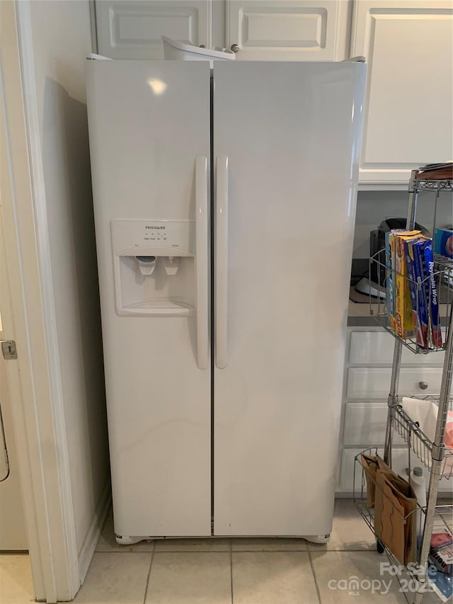 interior details with white fridge with ice dispenser and white cabinetry