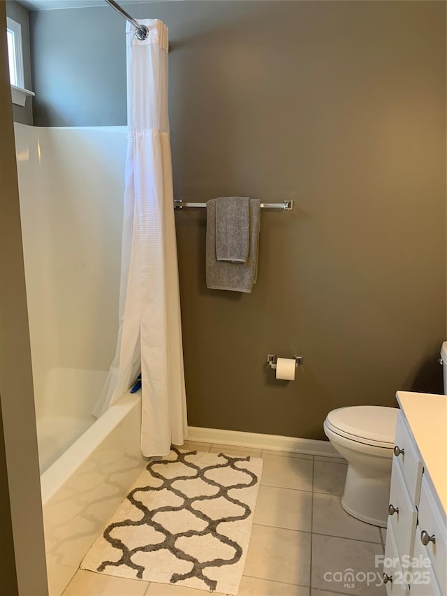 bathroom with toilet, baseboards, tile patterned flooring, vanity, and shower / bathtub combination with curtain