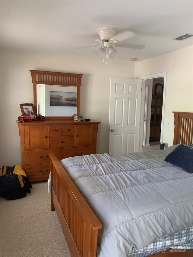 bedroom with a ceiling fan, visible vents, and carpet
