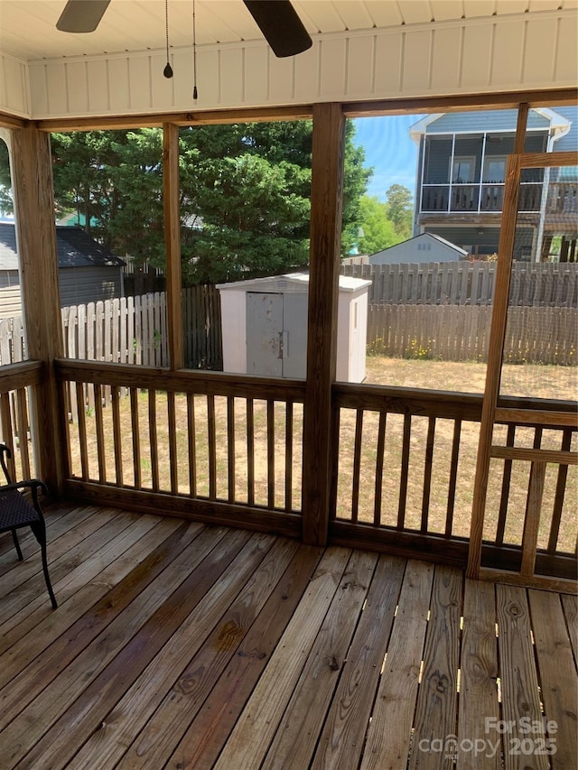 unfurnished sunroom with ceiling fan