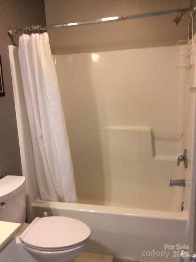 bathroom featuring vanity, toilet, and shower / bath combination with curtain
