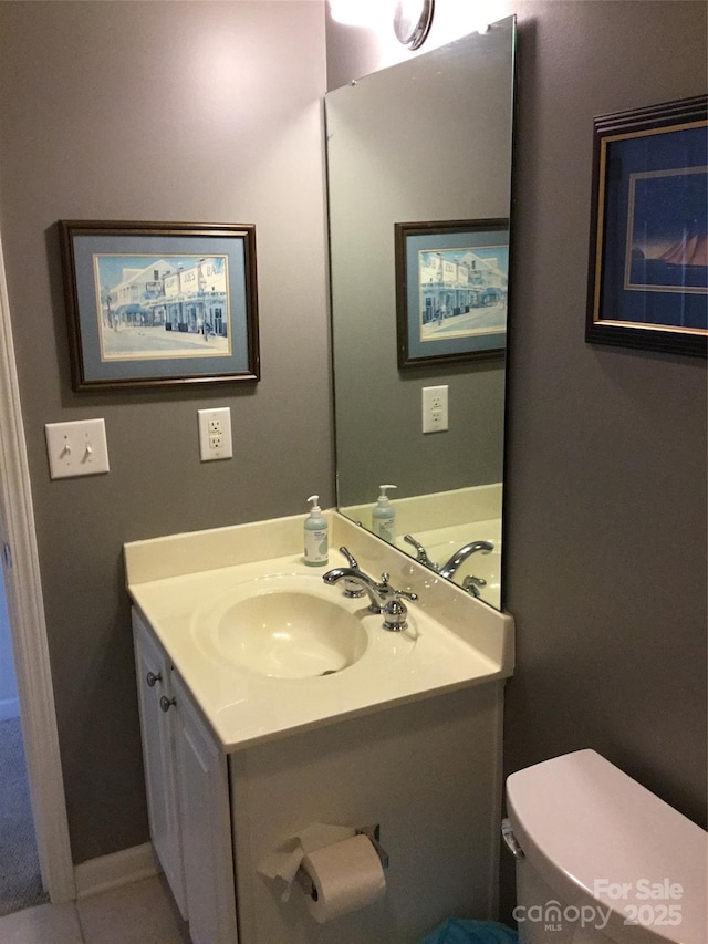 bathroom featuring toilet, tile patterned flooring, and vanity