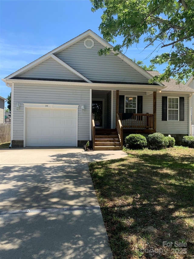 236 35th St NE, Oak Island, NC 28465 - single story home with an attached garage, a porch, and driveway