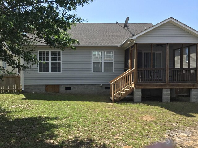 236 35th St NE, Oak Island, NC 28465 - rear view of property featuring a yard, roof with shingles, a sunroom, and crawl space