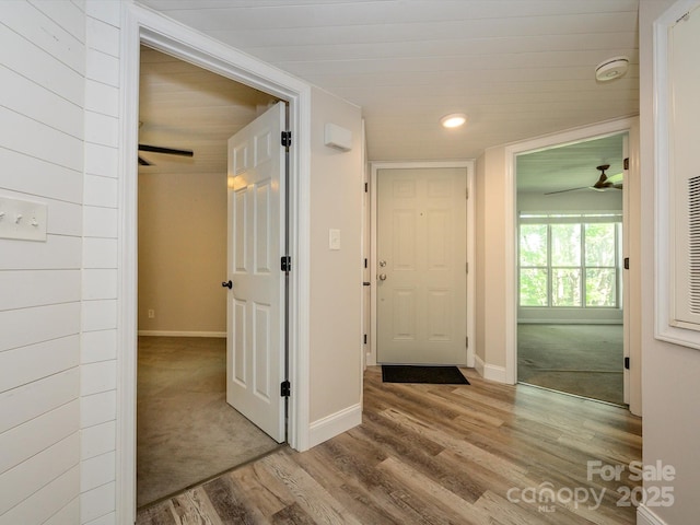 hallway with baseboards, recessed lighting, and wood finished floors
