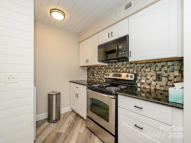 kitchen featuring visible vents, black microwave, light wood-type flooring, stainless steel electric range, and backsplash