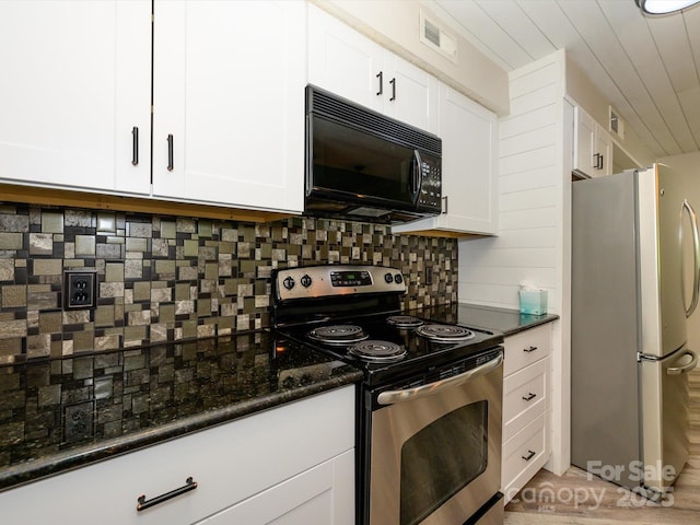 kitchen with dark stone countertops, stainless steel appliances, white cabinetry, tasteful backsplash, and visible vents