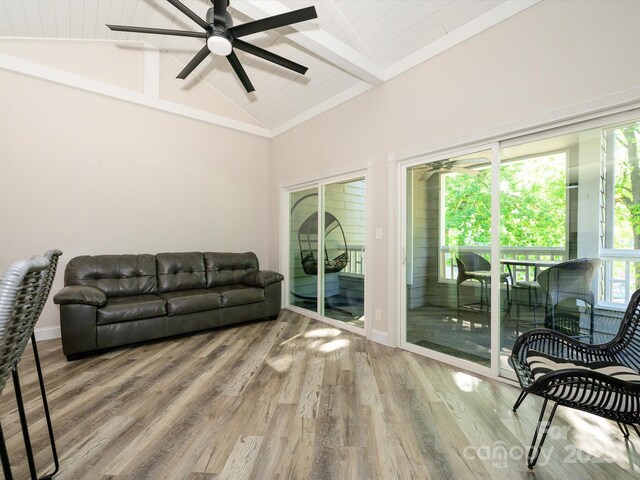 living area featuring a ceiling fan, beamed ceiling, wood finished floors, and high vaulted ceiling