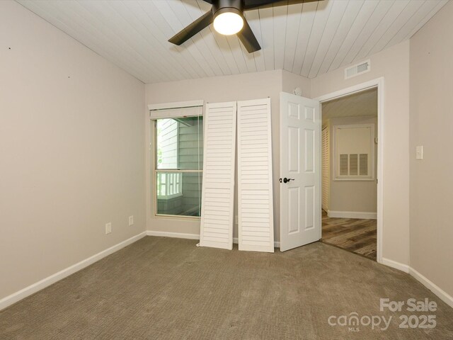 unfurnished bedroom with visible vents, a closet, baseboards, a ceiling fan, and carpet
