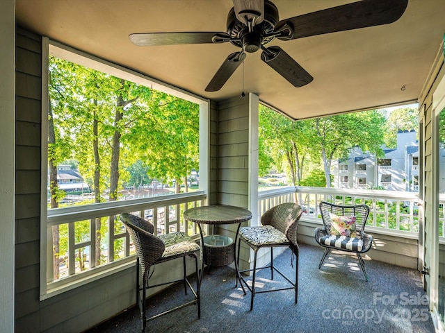 sunroom with ceiling fan and a wealth of natural light
