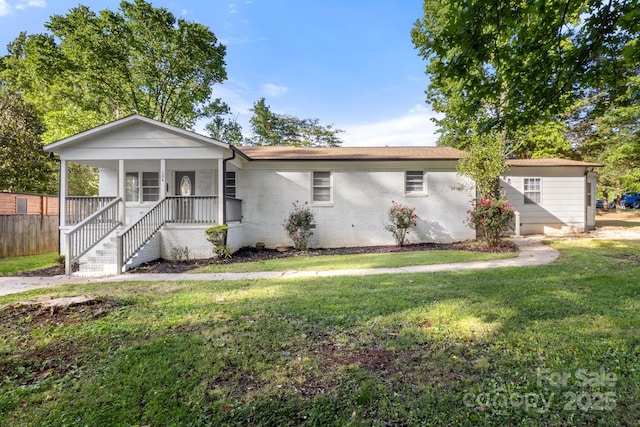 single story home featuring a front lawn, a porch, and brick siding