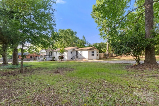view of front of home with fence and a front yard