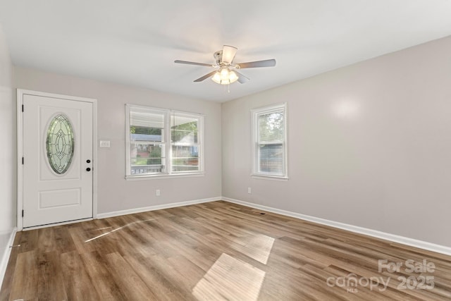entrance foyer featuring baseboards, ceiling fan, and wood finished floors