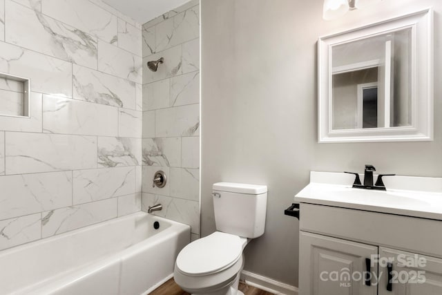bathroom featuring toilet, baseboards, vanity, tub / shower combination, and wood finished floors