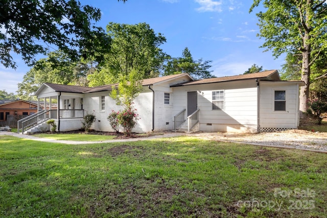 rear view of property featuring a porch, a lawn, entry steps, and crawl space