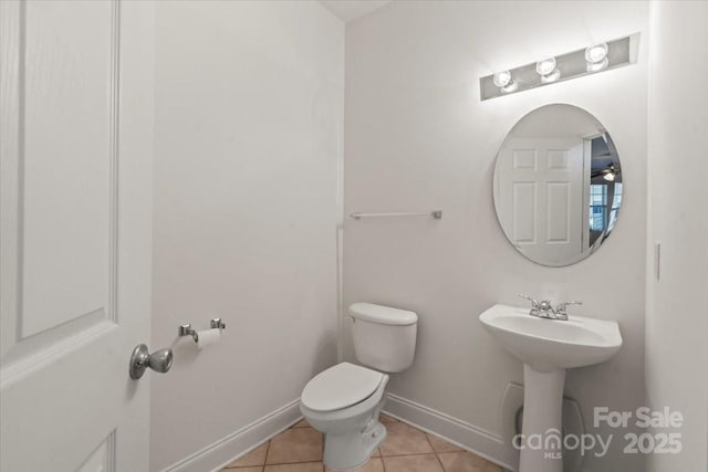 9047 Rosalyn Glen Rd, Cornelius, NC 28031 - half bathroom with tile patterned floors, toilet, baseboards, and a sink
