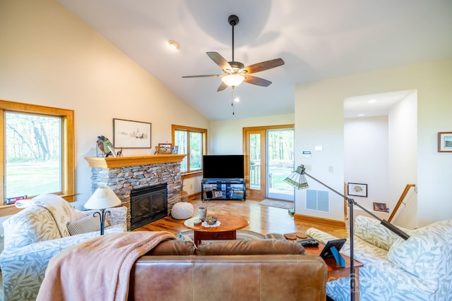958 Alta Vista Ln, Sparta, NC 28675 - living room with visible vents, wood finished floors, baseboards, a stone fireplace, and a ceiling fan