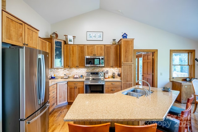 958 Alta Vista Ln, Sparta, NC 28675 - kitchen featuring a sink, a breakfast bar area, stainless steel appliances, lofted ceiling, and light wood-type flooring
