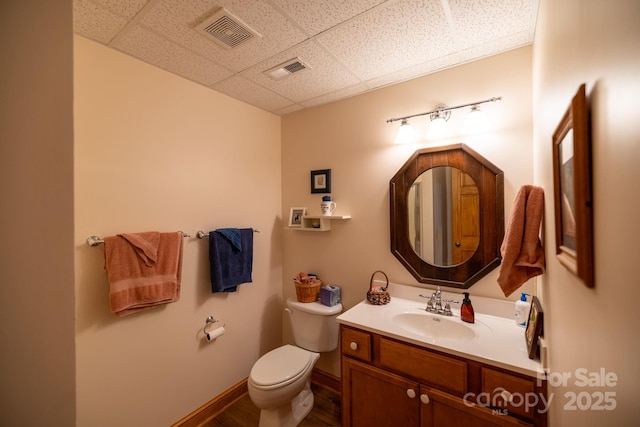 958 Alta Vista Ln, Sparta, NC 28675 - half bath featuring visible vents, vanity, wood finished floors, toilet, and a drop ceiling