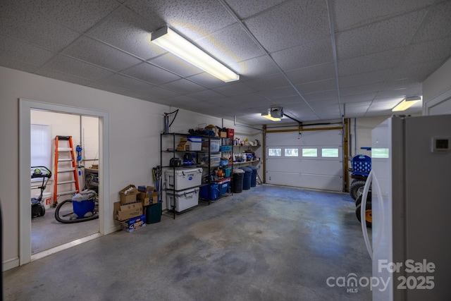958 Alta Vista Ln, Sparta, NC 28675 - garage featuring freestanding refrigerator and a garage door opener