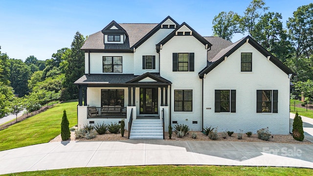 2854 Harlinsdale Dr, Rock Hill, SC 29732 - modern farmhouse featuring a front yard, roof with shingles, brick siding, crawl space, and a porch