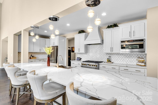 2854 Harlinsdale Dr, Rock Hill, SC 29732 - kitchen featuring light stone counters, a sink, premium range hood, stainless steel appliances, and decorative backsplash