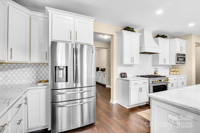 2854 Harlinsdale Dr, Rock Hill, SC 29732 - kitchen with light stone countertops, dark wood-style floors, premium range hood, white cabinetry, and stainless steel appliances