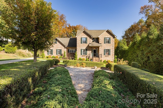 traditional-style house featuring stone siding