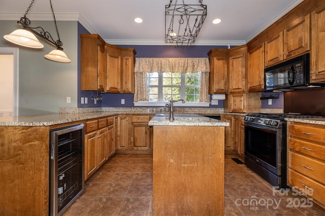 kitchen featuring a kitchen island, crown molding, a sink, black appliances, and wine cooler