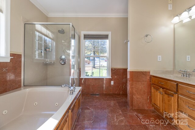 bathroom featuring crown molding, tile walls, an enclosed shower, vanity, and a whirlpool tub