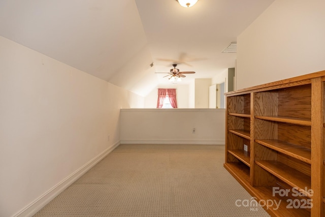 bonus room with ceiling fan, visible vents, light colored carpet, baseboards, and lofted ceiling