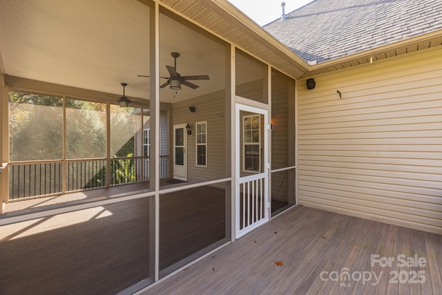 wooden deck featuring ceiling fan and a sunroom
