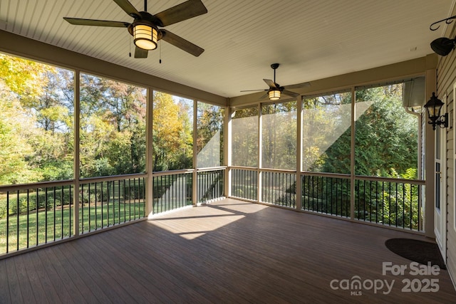 unfurnished sunroom featuring ceiling fan
