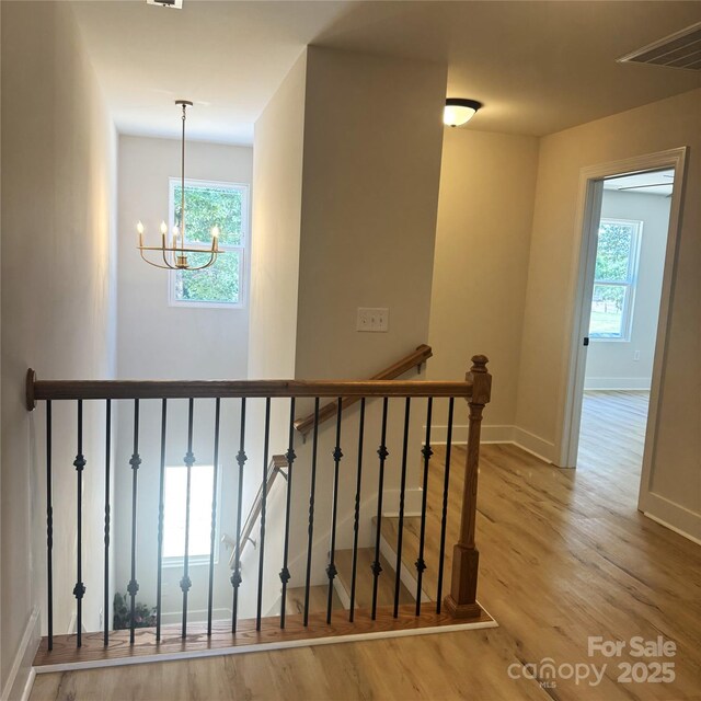 3114 Ansonville Rd, Marshville, NC 28103 - stairway featuring wood finished floors, a chandelier, plenty of natural light, and baseboards