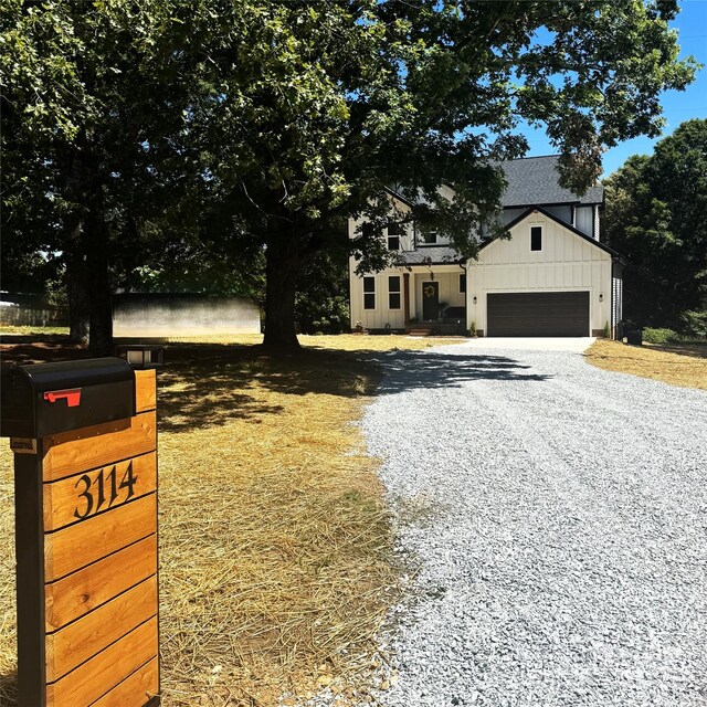 3114 Ansonville Rd, Marshville, NC 28103 - modern farmhouse featuring board and batten siding, driveway, an attached garage, and a shingled roof