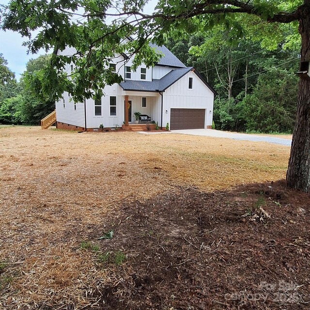 3114 Ansonville Rd, Marshville, NC 28103 - modern inspired farmhouse featuring board and batten siding, roof with shingles, concrete driveway, and a porch