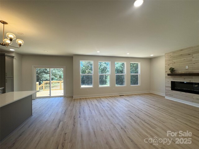 3114 Ansonville Rd, Marshville, NC 28103 - unfurnished living room with recessed lighting, a large fireplace, baseboards, a chandelier, and light wood-style floors
