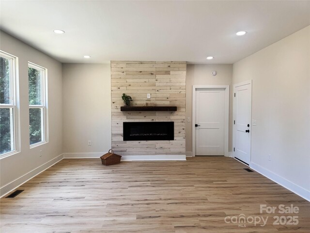 3114 Ansonville Rd, Marshville, NC 28103 - unfurnished living room with wood finished floors, recessed lighting, baseboards, and a fireplace