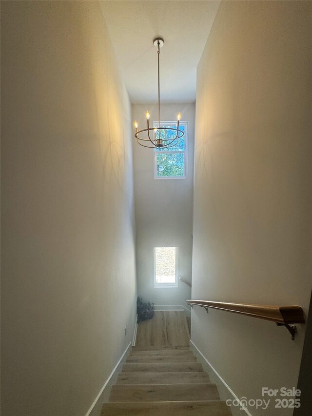 3114 Ansonville Rd, Marshville, NC 28103 - stairway featuring a chandelier, wood finished floors, plenty of natural light, and baseboards