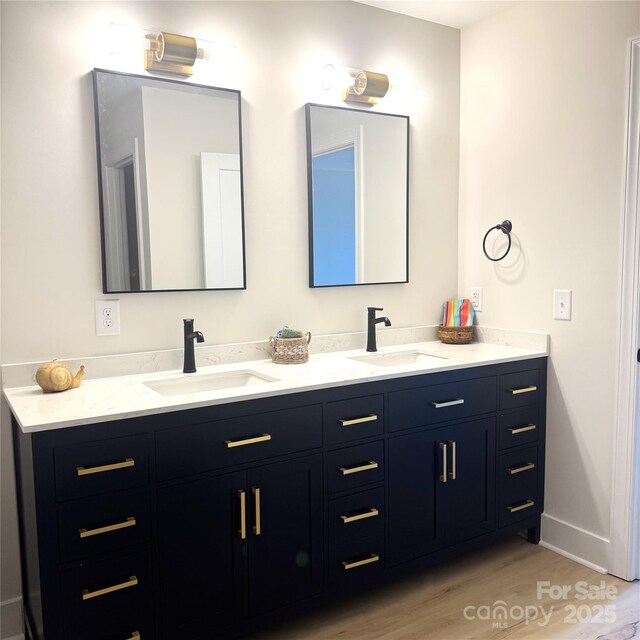 3114 Ansonville Rd, Marshville, NC 28103 - bathroom with double vanity, wood finished floors, and baseboards