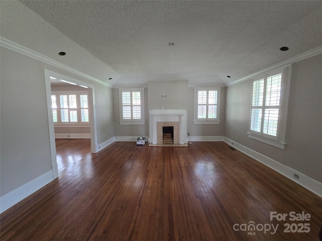 unfurnished living room featuring ornamental molding, a fireplace, a textured ceiling, and lofted ceiling