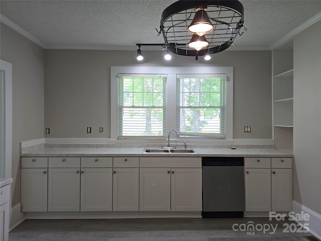 kitchen featuring crown molding, a sink, dishwasher, light countertops, and a textured ceiling