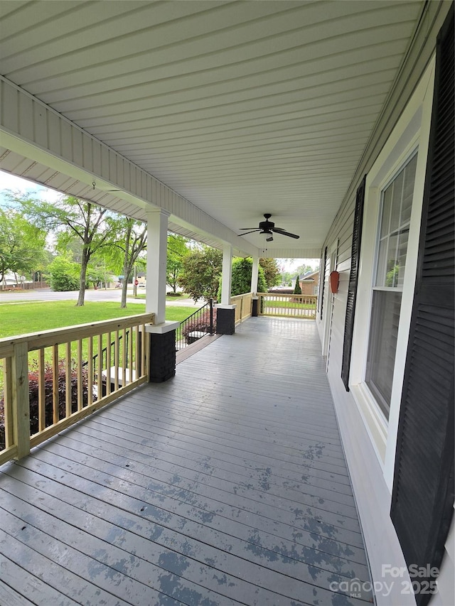deck with covered porch and a yard