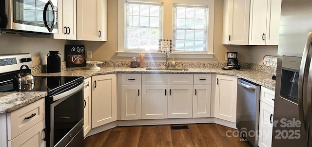 169 Freeze Ave NW, Concord, NC 28025 - kitchen with stainless steel appliances, dark wood-type flooring, white cabinetry, and light stone counters