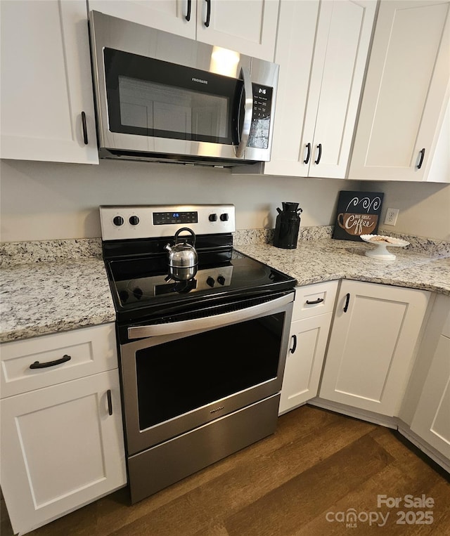 169 Freeze Ave NW, Concord, NC 28025 - kitchen featuring stainless steel appliances, dark wood-type flooring, white cabinets, and light stone counters