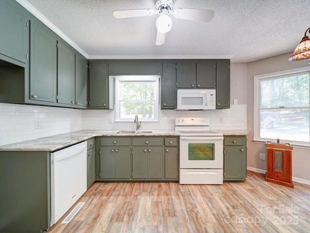 4901 Pine Oaks Dr, Monroe, NC 28112 - kitchen featuring a sink, tasteful backsplash, white appliances, and a textured ceiling