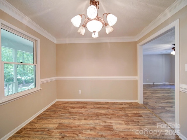 4901 Pine Oaks Dr, Monroe, NC 28112 - unfurnished room featuring crown molding, baseboards, ceiling fan with notable chandelier, and wood finished floors