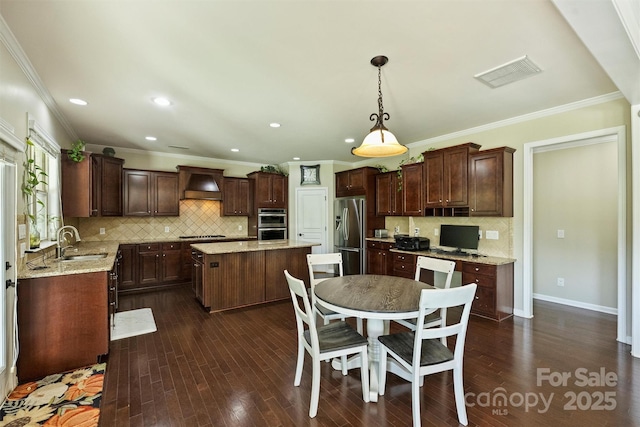 9825 Ardrey Woods Dr, Charlotte, NC 28277 - kitchen with visible vents, a kitchen island, tasteful backsplash, a sink, and appliances with stainless steel finishes