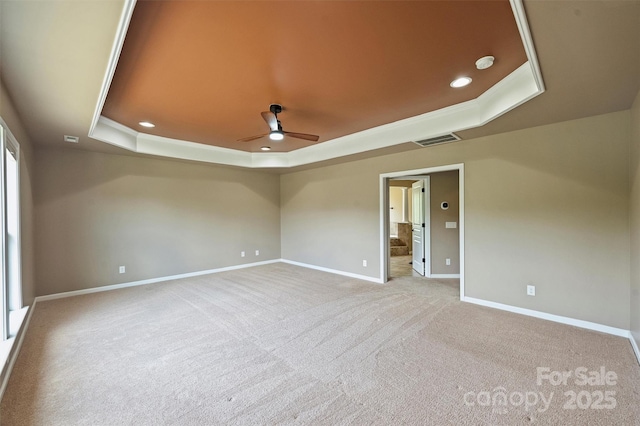 9825 Ardrey Woods Dr, Charlotte, NC 28277 - empty room featuring a raised ceiling, ceiling fan, baseboards, and carpet flooring