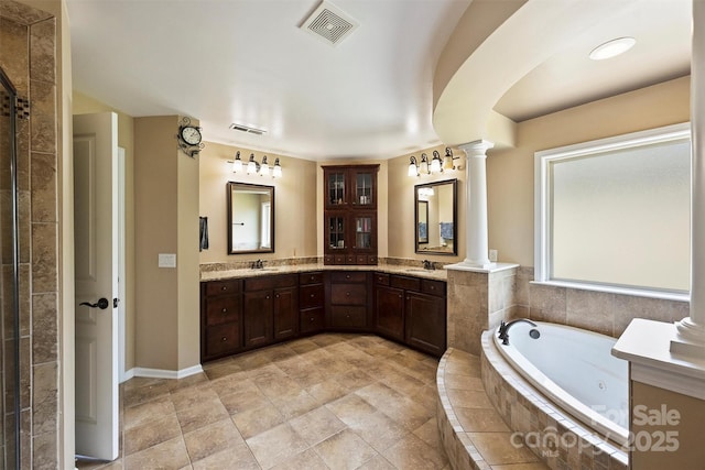 9825 Ardrey Woods Dr, Charlotte, NC 28277 - bathroom featuring a sink, a jetted tub, decorative columns, and visible vents